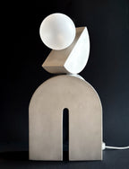 Lampe TOTEM Switch&Match en aluminium brut et globe en verre, vue de face sur fond sombre
